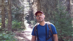 Eric Engel on a trail in pine forest
